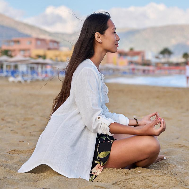 optyoung-woman-practicing-yoga-on-the-beach-2023-11-27-05-28-12-utc